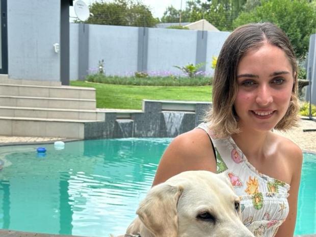 PADI Ambassadiver Jessica Pita sitting for a photo with her dog.